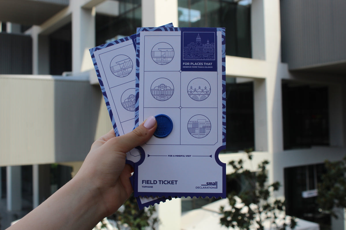 Field Ticket held in front of the building